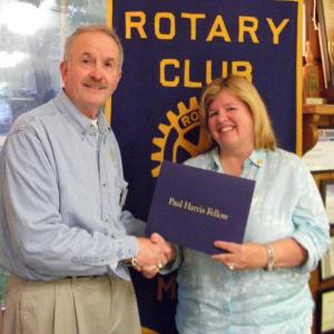 Rotary President Jim Botti presents a Paul Harris Award to Margi Spratt for her work on the club's annual auction and flea market. Courtesy of Connie Jones Rotary President Jim Botti presents a Paul Harris Award to Margi Pratt for her work on the club's annual auction and flea market. Courtesy of Connie Jones