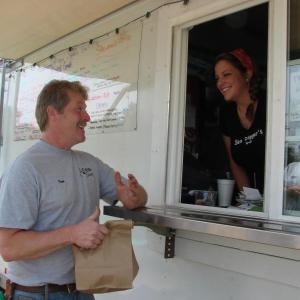 First-time customer Wayne Eugley of South Bristol picks up his order from Sea Digger's Grub co-owner Sydney Morin. SUSAN JOHNS/Wiscasset Newspaper