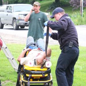 Herb Reno, 46, of Bath is loaded into a gurney after falling off a 25 foot roof. RYAN LEIGHTON/Boothbay Register