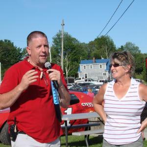 Wiscasset Speedway announcer and promoter Ken Minott, left, and track co-owner Vanessa Jordan address the crowd at a dedication of “Wilford's,” a concession stand named in honor of Wilford Cronk. Cronk  built the track in the 1960s. He died earlier this year. SUSAN JOHNS/Wiscasset Newspaper