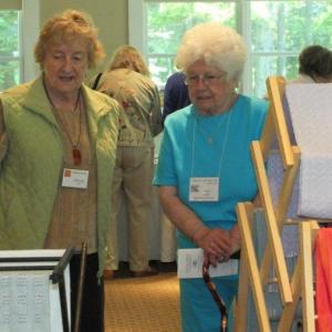 Ursula Smith, left, talks about her woven works at the Vendor's Market.  LISA KRISTOFF/Boothbay Register