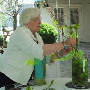 Floral designer and Judges Council member Sandra Leonard, seasonally of Southport, artfully places green chrysanthemums in one of four designs. LISA KRISTOFF/Boothbay Register