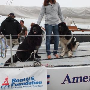 Michelle Levano, a summer intern, poses with Newfoundlands Smudge and Hickory, the furry mascots of the Rozalia Project. RYAN LEIGHTON/Boothbay Register