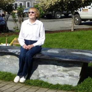 Gloria Taliana sits on the stone memory bench that honors her late husband, Jim Taliana. RYAN LEIGHTON/Boothbay Register