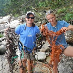 Michelle Levano and Marina Garland pick up trash on the shores of Hurricane Island before returning to Boothbay on June 24. Courtesy of the Rozalia Project Michelle Levano and Marina Garland pick up trash on the shores of Hurricane Island before returning to Boothbay on June 24. Courtesy of the Rozalia Project