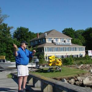 Forrest Faulkingham demonstrates a fishing technique at the Recreational Pier in Wiscasset. Below: Faulkingham’s clients have the use of equipment like this colorful fishing fly. SUSAN JOHNS/Wiscasset Newspaper Forrest Faulkingham demonstrates a fishing technique at the Recreational Pier in Wiscasset. SUSAN JOHNS/Wiscasset Newspaper