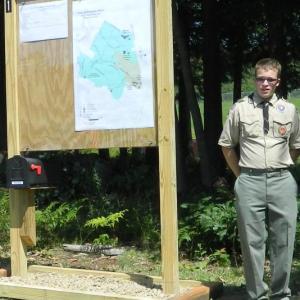 David Marcus stands beside one of the trail kiosks recently installed along the West Woods and Morris Farm trail system. Marcus came up with the plan for the kiosks for his Eagle Scout project. Courtesy of Robert Marcus