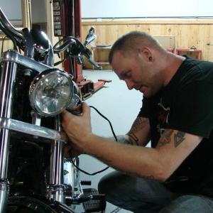 Darron Pierce changes a part on a customer's bike at the new Route 1 business, Twisted Iron Customs. SUSAN JOHNS/Wiscasset Newspaper