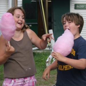 A young girl and boy enjoy some cotton candy at the Camp K Carnival. KEVIN BURNHAM/Boothbay Register