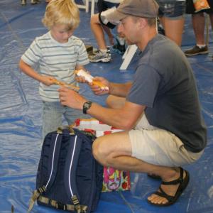 High school teacher and coach Bryan Dionne helps his son load a handful of new pencils into his new backpack. KEVIN BURNHAM/Boothbay Register