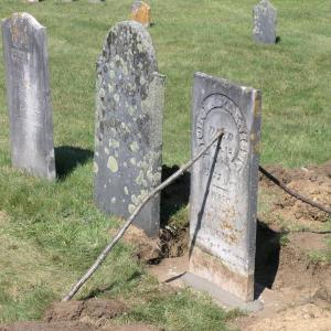 A stone in Kenniston Cemetery is cemented back into place. Courtesy of Merlin Gray