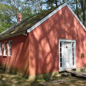The trees and sun work together to make a pretty pattern on the one-room schoolhouse. SUSAN JOHNS/Wiscasset Newspaper