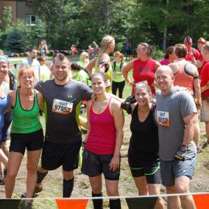 Looking a little wearier but undaunted local teammates pose with another participant at the end. Courtesy of John Mitkus 