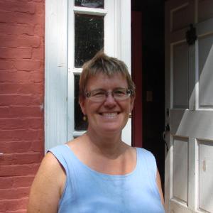 Stephenson is all smiles outside the Salt Marsh School she and husband Tom Blackford bought in early August. SUSAN JOHNS/Wiscasset Newspaper