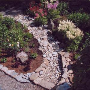 Aerial view from the bridge, showing the gardens divided by a dry river bed of stone constructed by Carlton Plummer. Courtesy of Carlton Plummer Aerial view from the bridge, showing the gardens divided by a dry river bed of stone constructed by Carlton Plummer. Courtesy of Carlton Plummer