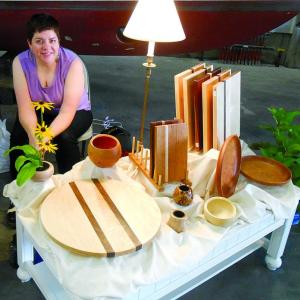 Amé Mundy of West Boothbay Harbor, who designs under the Wooden Whimsy name, diplays some of her functional wood art at Lincoln Art Festival's Arts & Yachts show held at the Boothbay Region Boatyard. GARY DOW/Boothbay Register