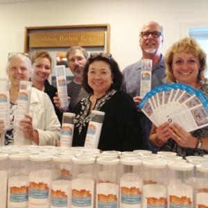 The Getting Away Committee displaying its colorful donation cans and fliers. Pictured from left, Melba Gunnison, Jane Dow, Jason Sheckley, Audrey Miller, Gardiner Rapelye Jr. and Catherine Wygant Fossett. RYAN LEIGHTON/ Boothbay Register 
