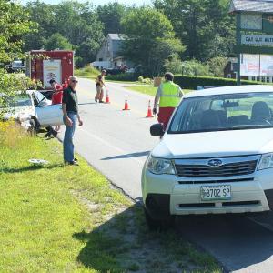 Frederick Fahlsing looks over the damage to his Subaru after he was rear ended by Michael Andretta on August 1. RYAN LEIGHTON/ Boothbay Register