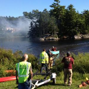 Firefighters wait on the mainland for a boat to be ferried out to the island in “The Marsh” in East Boothbay Saturday afternoon. JOE GELARDEN/Boothbay Register