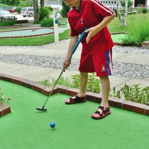 A young boy participates in a previous Maine State Minigolf Open at Dolphin Mini Golf in Boothbay. KEVIN BURNHAM/Boothbay Register