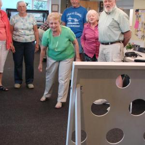 Cam Johnson is up “at bat,” in a beanbag-toss version of baseball following an August 7 supper at the senior center in Wiscasset. SUSAN JOHNS/Wiscasset Newspaper