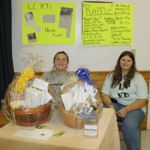 Chelsea Graves, left, and Tabetha Harrington are in charge of selling raffle tickets to benefit the Lincoln County K-9 program at the Hometown Heroes event. KEVIN BURNHAM/Boothbay Register 