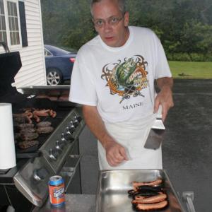 Rotary chef Kim Mills finishes another batch of grilled hot dogs. KEVIN BURNHAM/Boothbay Register
