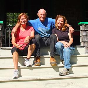 Nancy Thayer, Allen’s sister, Allen and Gracie sit on the steps at the big summer cottage Allen's grandfather, Frank Leonard Allen, built in 1912. The pair come to Boothbay Harbor every summer. When Allen's not sailing, Boothbay Harbor is his home port. While here, they stay in the cottage, which is at the top of Crest Avenue, beyond the Sprucewold cabins. The house has remained in the Allen family. It now belongs to the younger Allen and his three siblings, Nancy, Gregory and Bruce, and their familes. 
