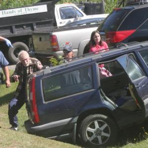 The driver of this Volvo involved in the accident at the Irving gas station walks around the car while being directed to an ambulance by one of the attendants at the scene. KEVIN BURNHAM/Boothbay Register