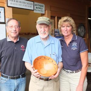 Master woodturner Lou Landry donates a handcrafted bowl to the Boothbay Charities Classic for the third consecutive year. Pictured from left are Mike Feldman, chairman of Special Olympics Maine, Lou Landry and Brenda Blackman, co-chairman of the Charities Classic. Landry's woodworking has spanned over 50 years. His studio, Ocean Point Woodturning on Van Horn Road, features unique bowls and vases, both segmented and unsegmented wood composites consisting of many colors and textures. This year, Landry's bowl 