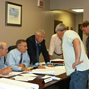Looking over plans for the new Fish Pier building are, from left, Board Chairman Bill Hamblen, Selectman Russ Hoffman, Selectman Jay D. Warren, Town Manager Tom Woodin, tenant Chuck Fuller and Public Works Director Jody Lewis. KATRINA CLARK/Boothbay Register