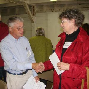 Larry Hayter, left, of the Old Bristol Historical Society, meets Harriet Vaughan of the Whitefield Historical Society, in the Nickels-Sortwell Barn in Wiscasset on September 22. SUSAN JOHNS/Wiscasset Newspaper