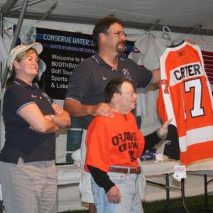 Tom and Bonnie Erskine auction off a jersey with the late Special Olympian Howard Gordon for the Boothbay Charities Classic in 2011. Courtesy of John Edwards