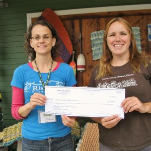 Lincoln County Animal Shelter receives a $300 donation as the July recipient. Elya Markert, Rising Tide Outreach Coordinator, left, presents the check to Carrie Koskela, Lincoln County Animal Shelter office manager. Courtesy of Rising Tide