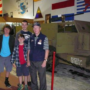 World War II veteran and museum volunteer Austin Carter provides a tour of the Cole Transportation Museum to Southport Scouts Jake Brewer, left, Liam Cullina, middle, and Jacob Bishopp, back. Courtesy of Sarah Sherman World War II veteran and museum volunteer Austin Carter provides a tour of the Cole Transportation Museum to Southport Scouts Jake Brewer (left), Liam Cullina (middle) and Jacob Bishopp (back). Courtesy of Sarah Sherman