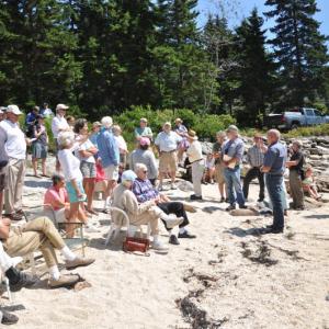 SOUTH BEACH residents listen to Bud Brown as he answers questions August 15. The South Beach dredging project, which would have involved minor blasting, was recently called off. BEN BULKELEY/Boothbay Register