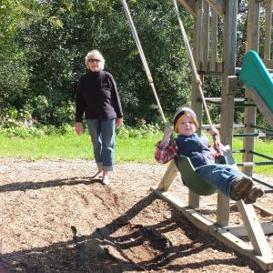 Ethel Stansfield gives Isaac Koskkowski a push on the swing. Stansfield celebrates her 30th year teaching at Sheepscot Valley. RYAN LEIGHTON/Boothbay Register