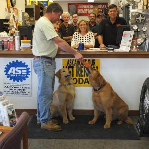 Hazen Smith accepts a gift certificate won by his daughter Megan at Hawke Motors, featuring mascots Perry and Peter Hawke. 