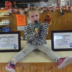 Addie Barter, daughter of Ice Cream Hut owner Katrina Dunsmore, poses with the Boothbay’s best ice cream award. 