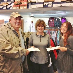 Janson’s Clothing Store owner Betty Maddocks (center) hands out gift certificates to Larry Oakes and Beth Raburn. 