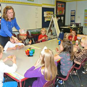 New first grade teacher Lindsey Ingraham, passing homemade cookies to her students. Clockwise from rear are: Angelina Patriotti, Anna Elizarkov, Lysander LeFerre, Dean Brewer, Zaid Osman, Lilliana Nein, Scarlett O'Brien, Madeline Orchard, and  Wyatt Lorrain. KATRINA CLARK/Boothbay Register