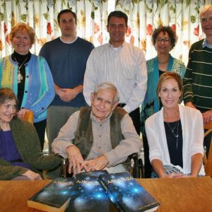 With four copies of his novel, “Angelesis,” resting in front of him, John VanOrsdell of Boothbay is joined at the unveiling by his wife, Alys, left, their daughter, Lisa Amundson, right, and in back, from left, Estelle Appel, Jim Chaousis, Emilio Coppola, Jill Tupper and Ed Kuljian. KEVIN BURNHAM/Boothbay Register