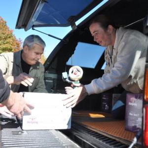 DENNIS BLACKMAN, left, Lou Scala and Blaisette Gauthier load boxes of food into a truck on October 18 at Hannaford's in Boothbay Harbor. The Boothbay Region Fish & Game Association donated 30 boxes of food to the Boothbay Region Food Pantry. BEN BULKELEY/Boothbay Register