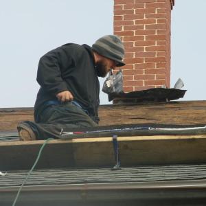 Photo of Josh Gallant of Augusta working on the roof of the 1811 jail in Wiscasset