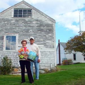 Faith and Joel Vittori hold the waste can behind Ernestine Dodge’s garage. SUZI THAYER/Boothbay Register