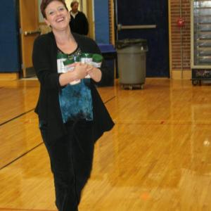 Booster Club president Heather O’Brien brings a load of Parmesan cheese to the banquet table. KEVIN BURNHAM/Boothbay Register