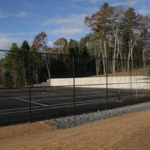 The fence is up, temporary lines are down but the new tennis courts on the Boothbay Harbor school campus won’t be ready to use until spring. KEVIN BURNHAM/Boothbay Register The fence is up, temporary lines are down but the new tennis courts on the Boothbay Harbor school campus won’t be ready to use until spring. KEVIN BURNHAM/Boothbay Register