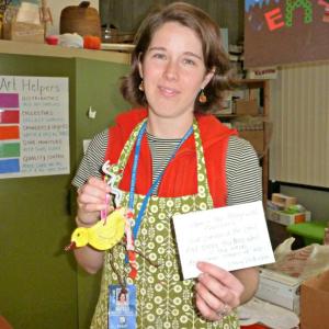 Boothbay Region Elementary School art teacher Jessica Nadeau holds a finished Hope Bird and the verse from an Emily Dickinson poem that inspired the project. KATRINA CLARK/Boothbay Register