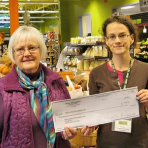 Tina Tucker, left, New Hope for Women Community Educator, and Elya Markert, Rising Tide Outreach & Marketing Coordinator. New Hope for Women accepted a $311.32 donation from Rising Tide Community Market as the October beneficiary of the Co-ops for Community Day program. Courtesy of Rising Tide