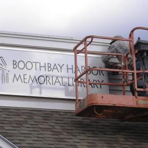 A new sign for the relocated Boothbay Harbor Memorial Library at the Meadow Mall is installed. Courtesy of Tim McFadden A new sign for the relocated Boothbay Harbor Memorial Library at the Meadow Mall is installed. Courtesy of Tim McFadden